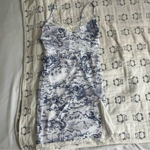A camisole slip dress with lace and cupid designs